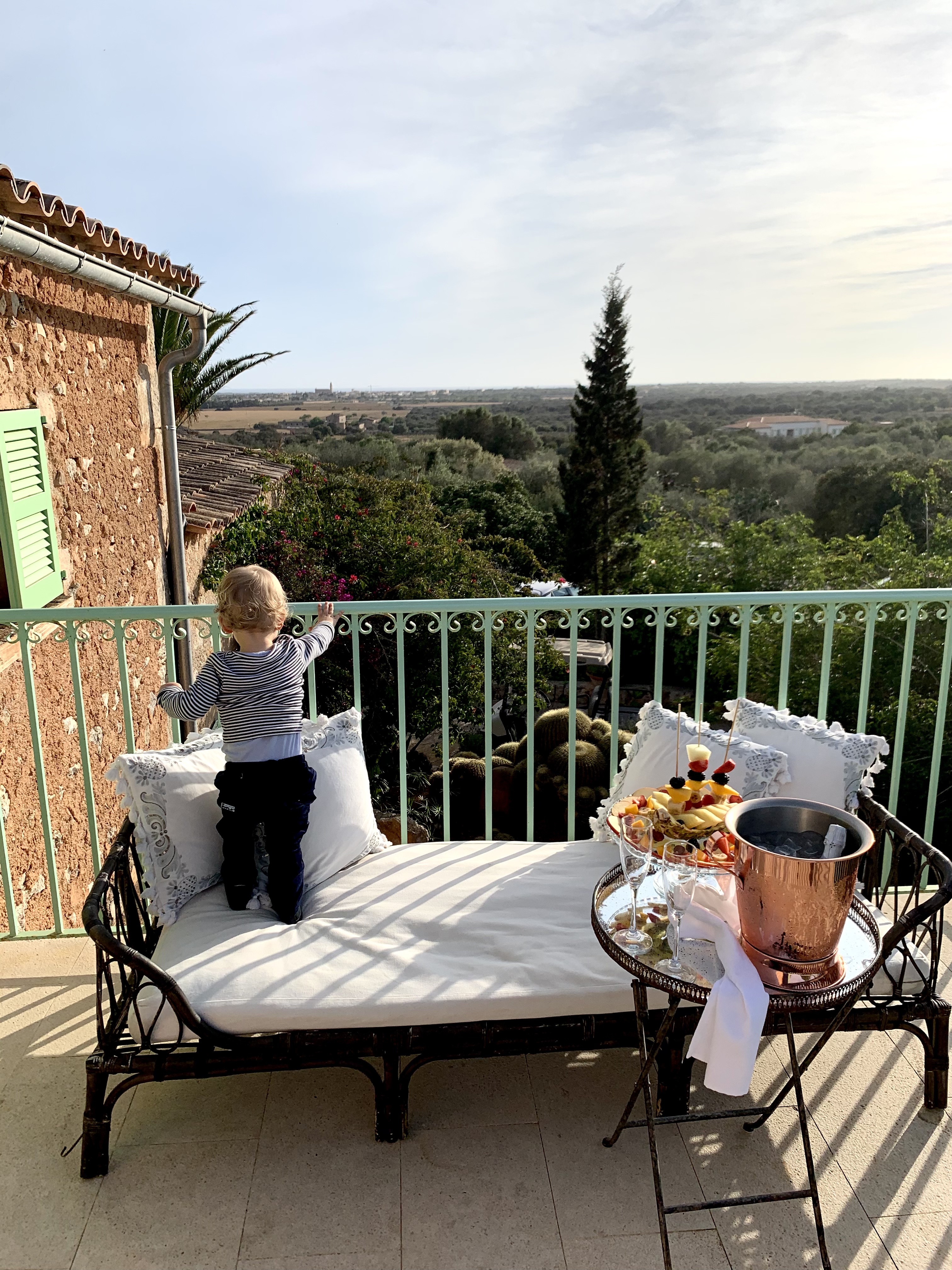 My son enjoying the terrace in our room at Finca Hotel Rural Es Turo. We loved spending here our evening watching the sunset! Truly special!